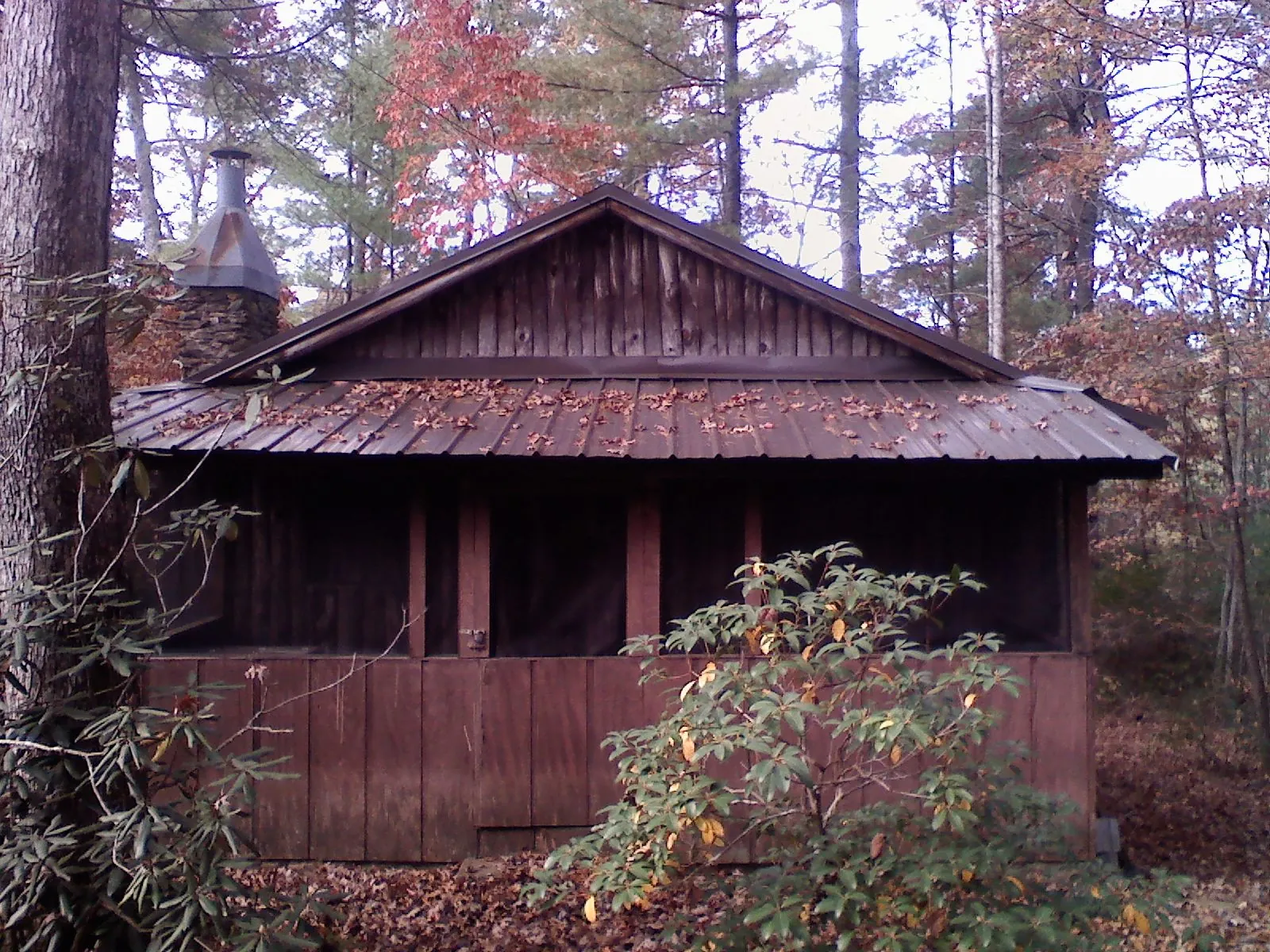 Metal roof over the screened porch of a rustic cabin in Crete